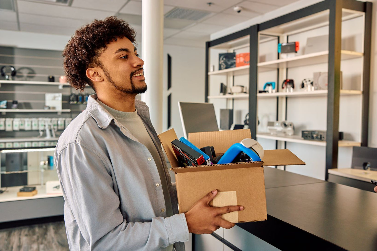 man holding a box of electronics