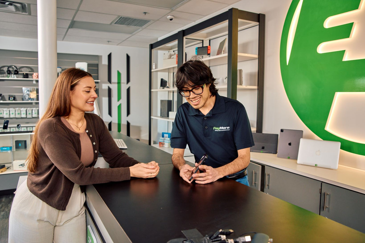 paymore employee inspecting electronics